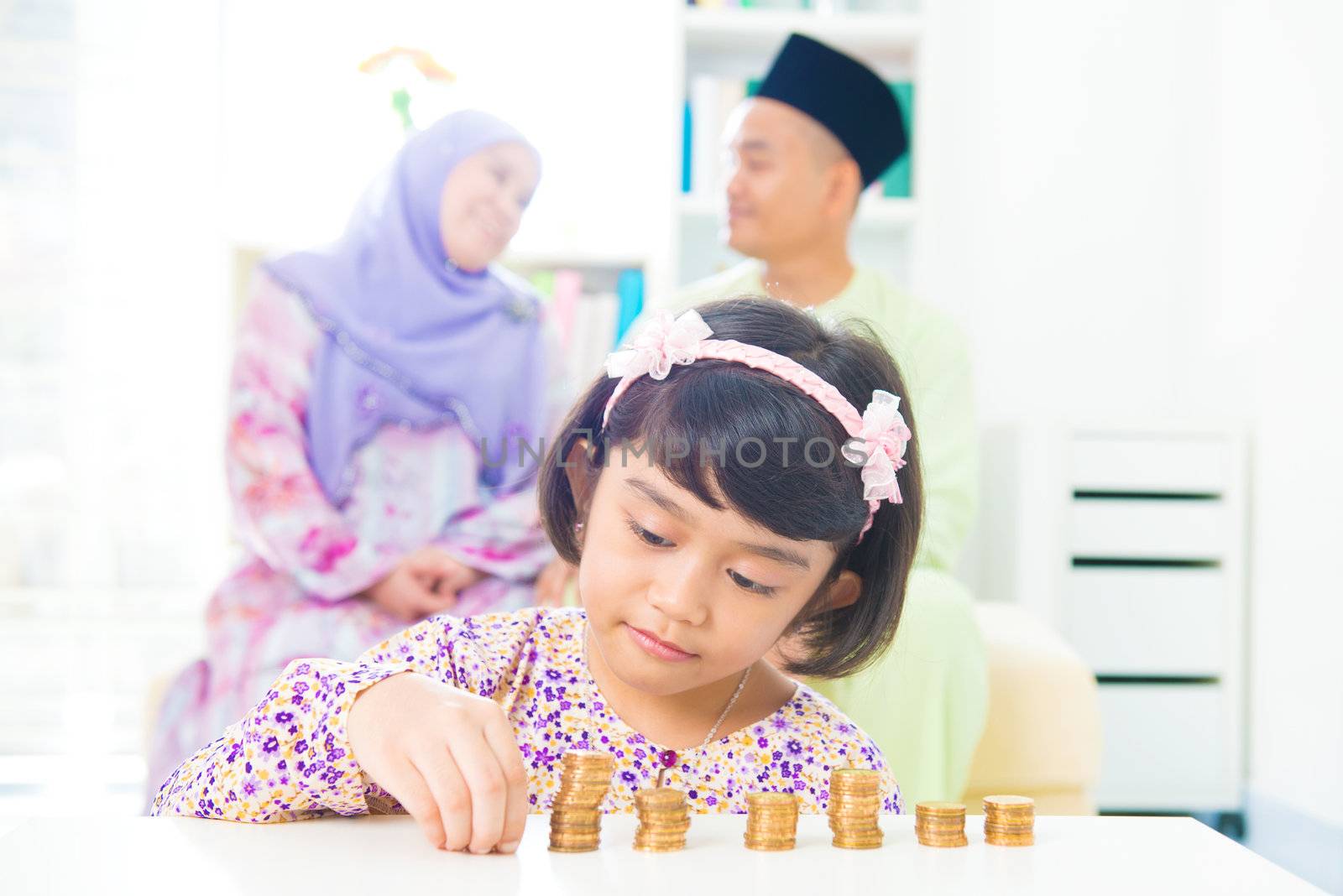 Southeast Asian girl money savings concept. Asian family living lifestyle.