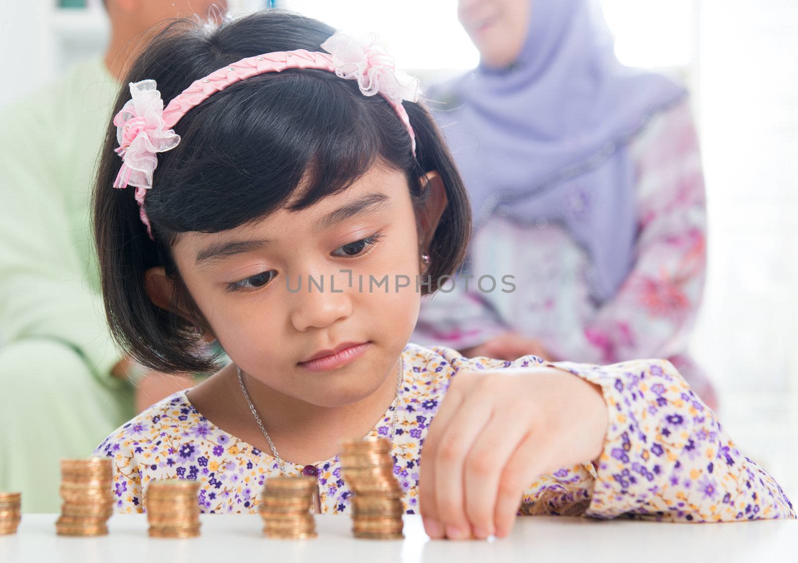 Muslim banking concept. Southeast Asian saving money at home, asian family living lifestyle.