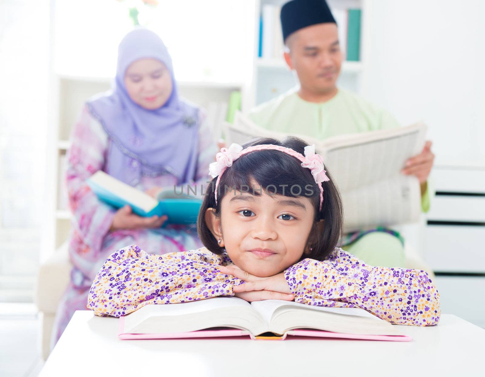 Southeast Asian girl reading at home. Muslim family living lifestyle