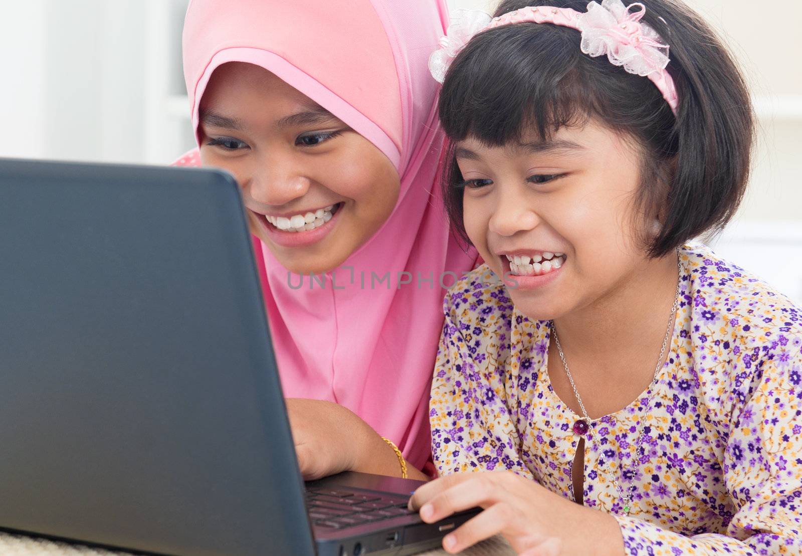 Southeast Asian females surfing internet at home. Malay Muslim girls.