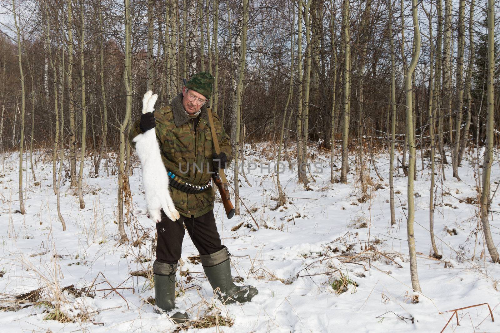 Hunter after a successful hunt for hares