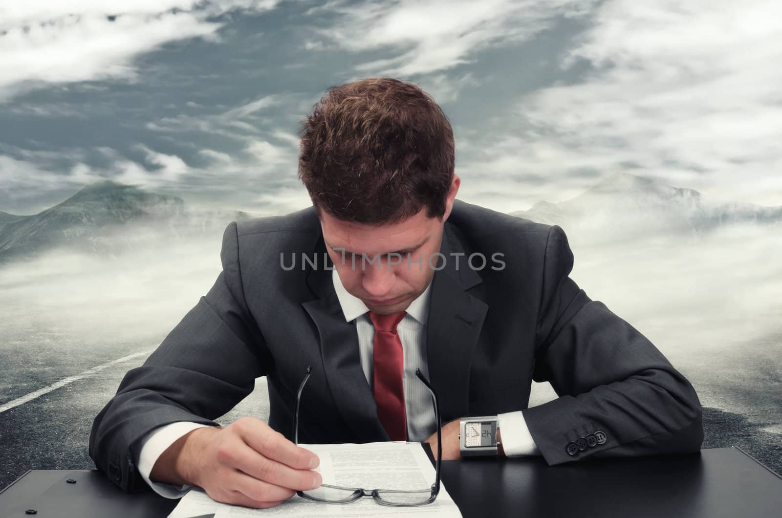 Young man at office reading an application form