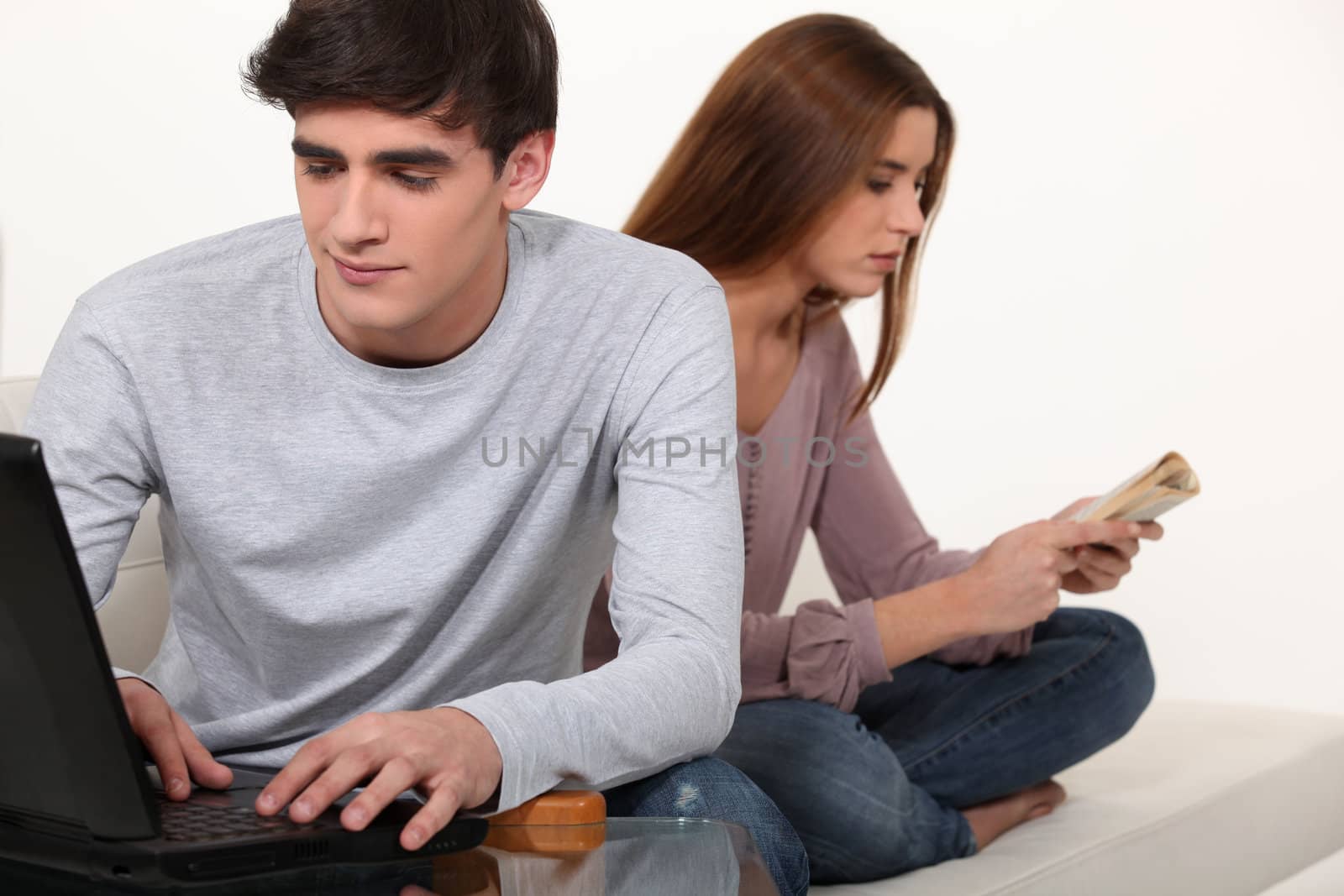 Couple with book and laptop