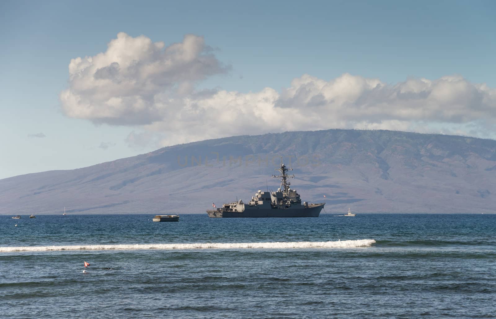 United States Navy Ship anchored off the coast of Maui, Hawaii.  The island of Lanai in background