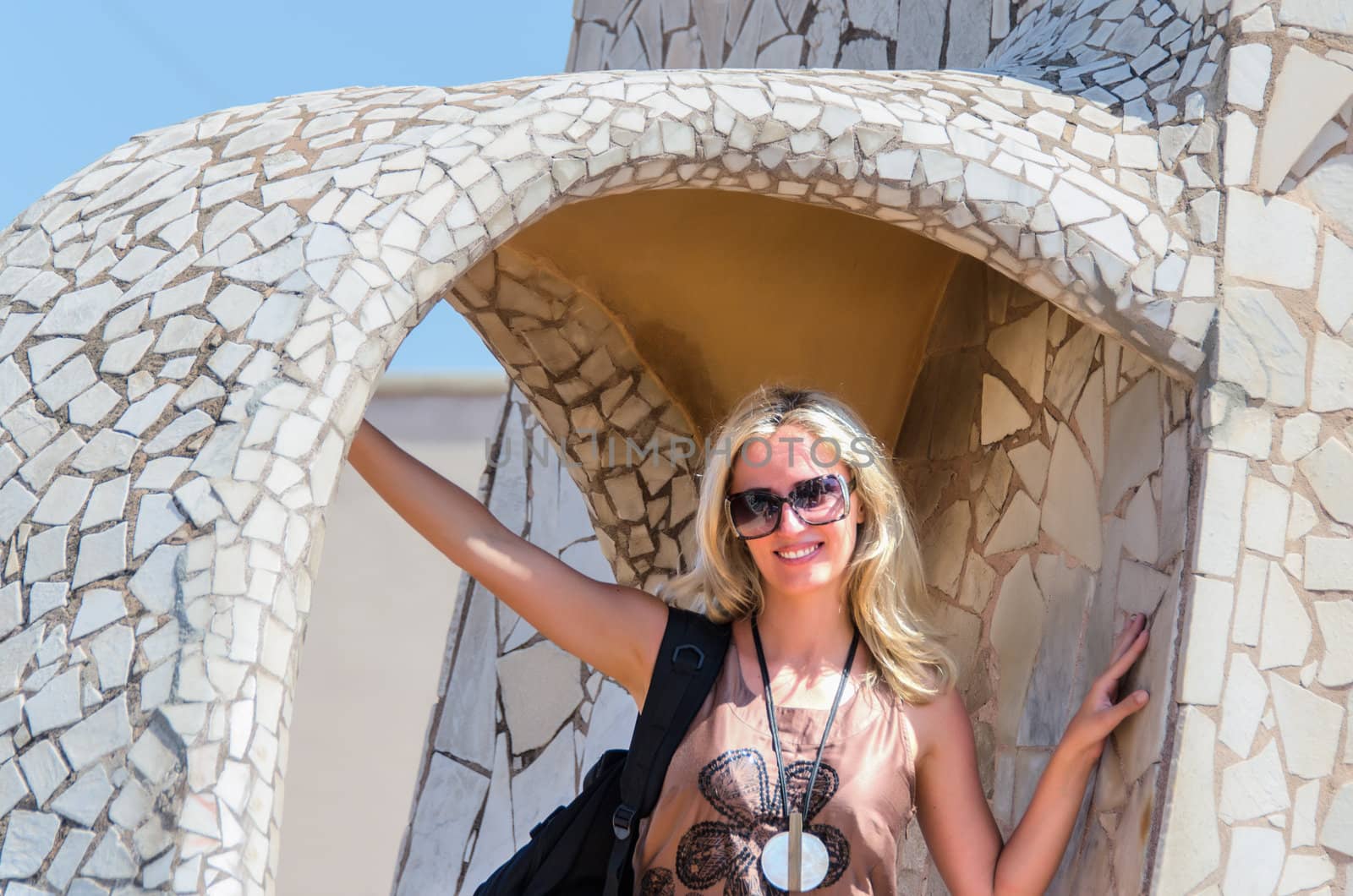 Smiling pretty blonde with sunglasses on a vacation trip by Nanisimova