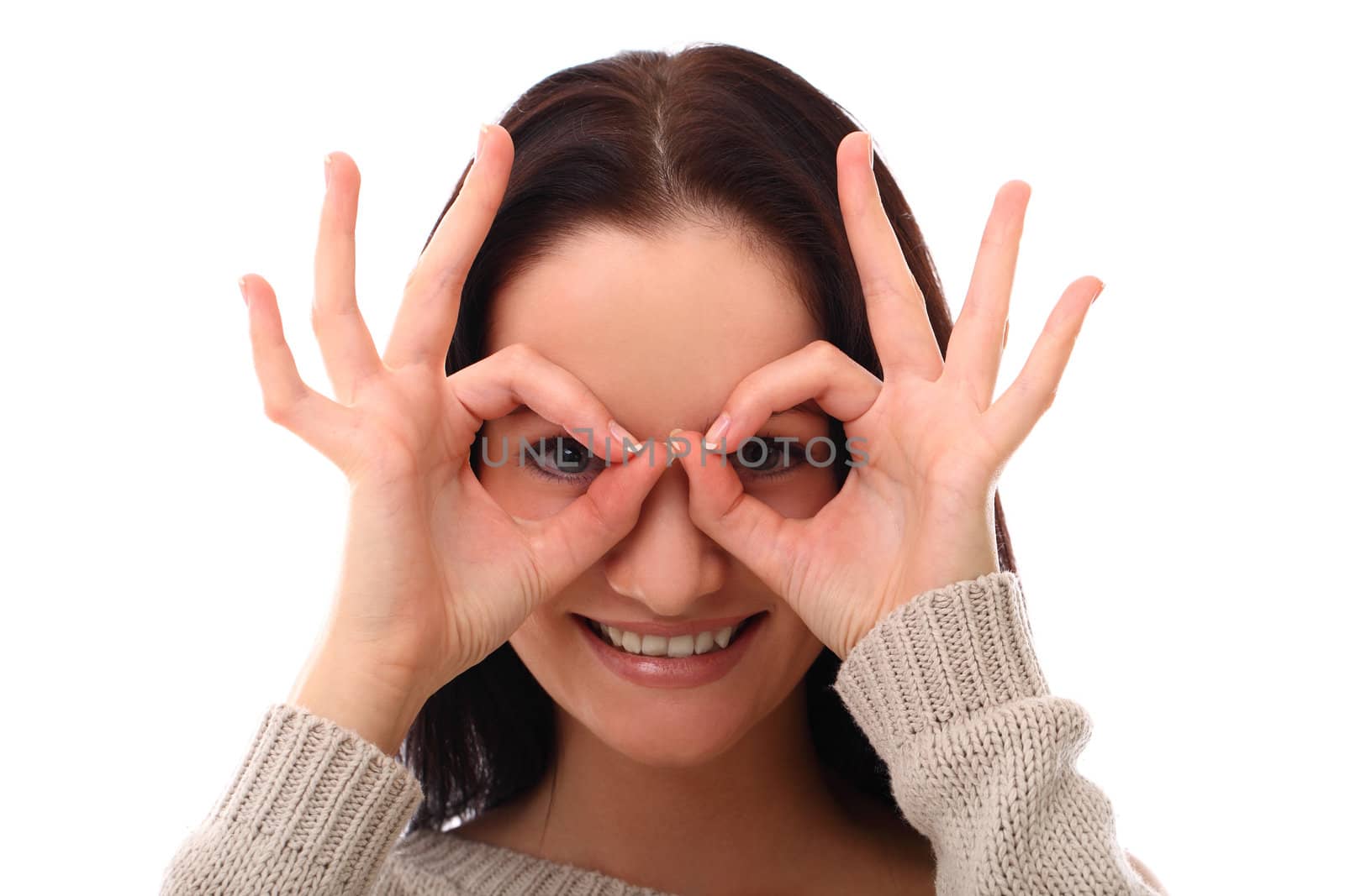 Young woman watching through fingers over a white background