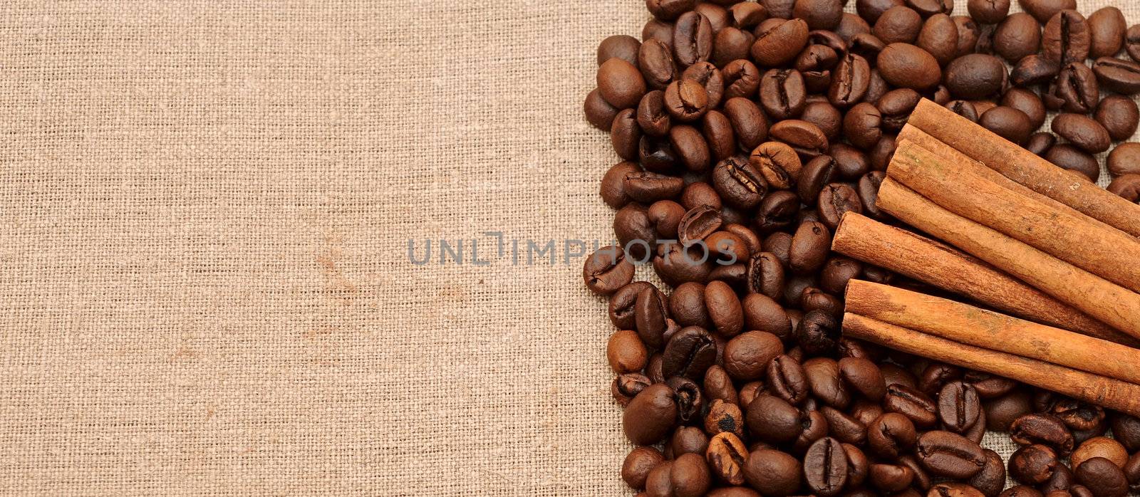 handful aromatic coffee beans with cinnamon 