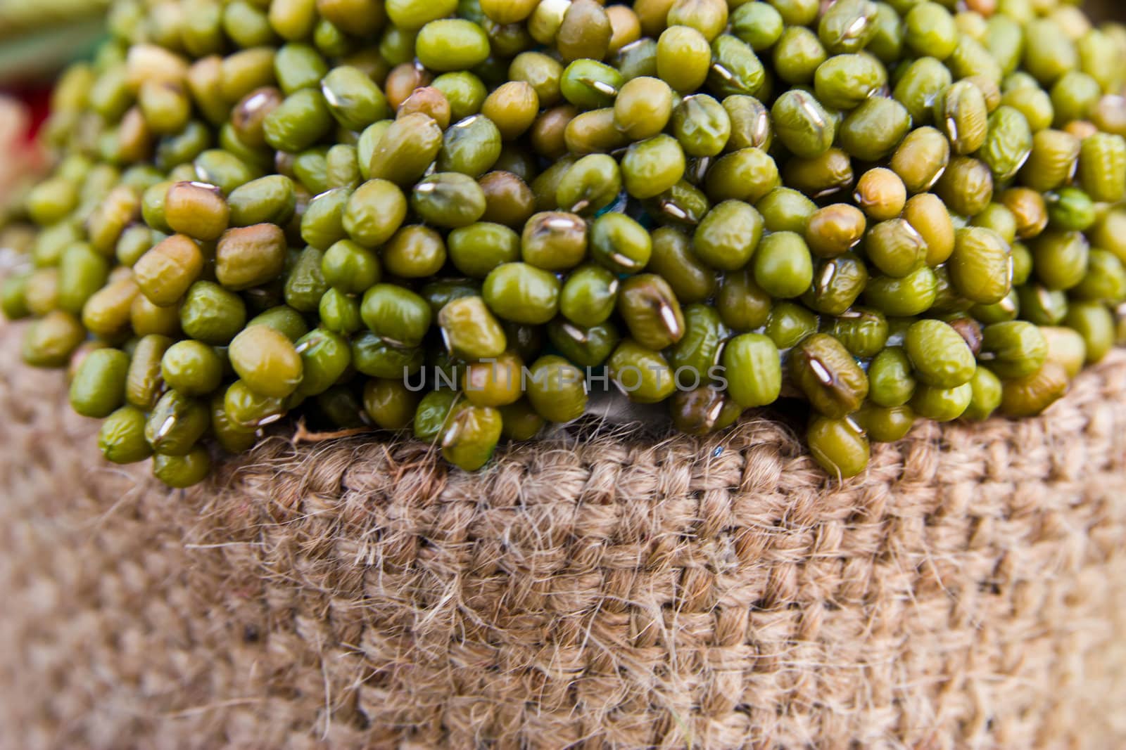 green mung bean on sack isolated in white background  by wasan_gredpree