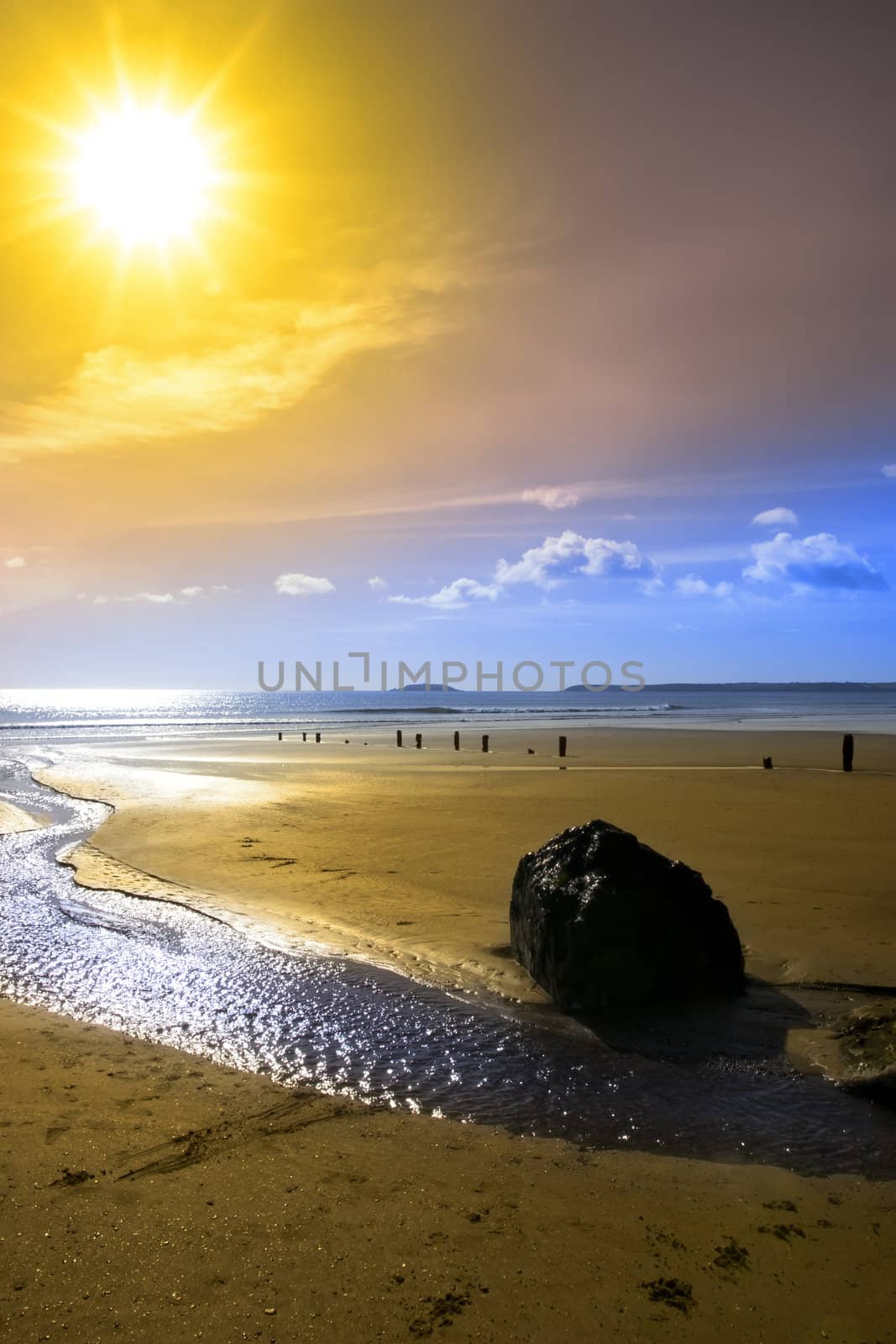 Beautiful yellow sun over the Youghal beach by morrbyte