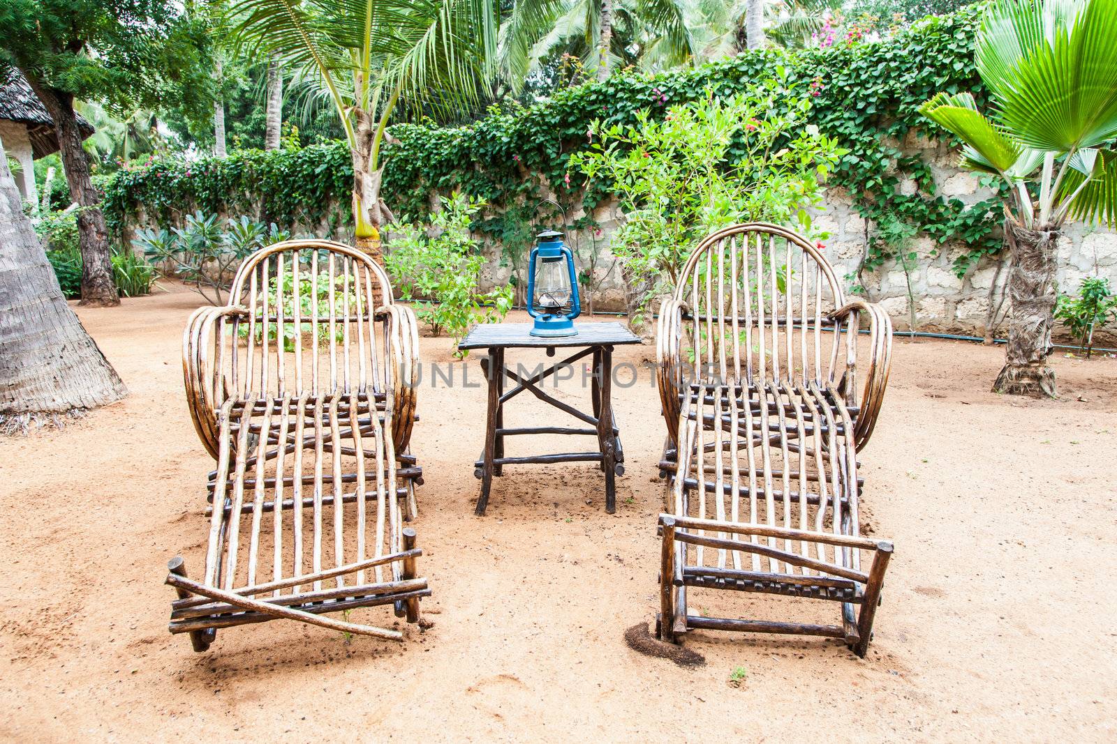 Kenya. Elegant furniture made of wood in an African garden