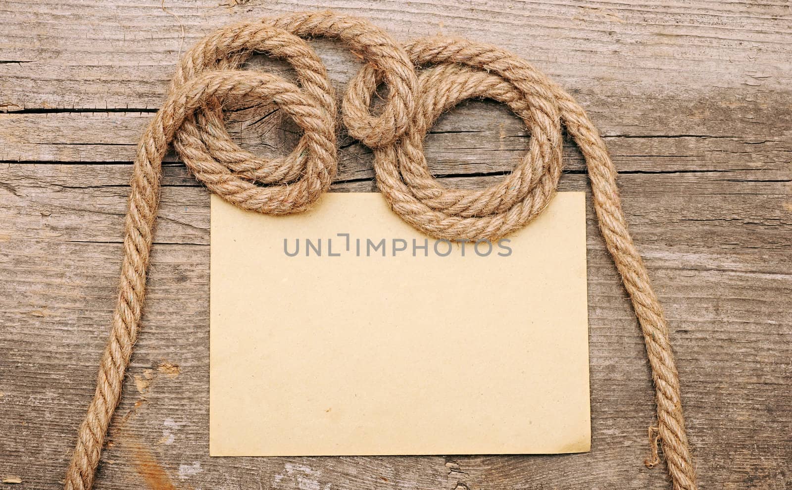 parchment paper and ship ropes on wood 
