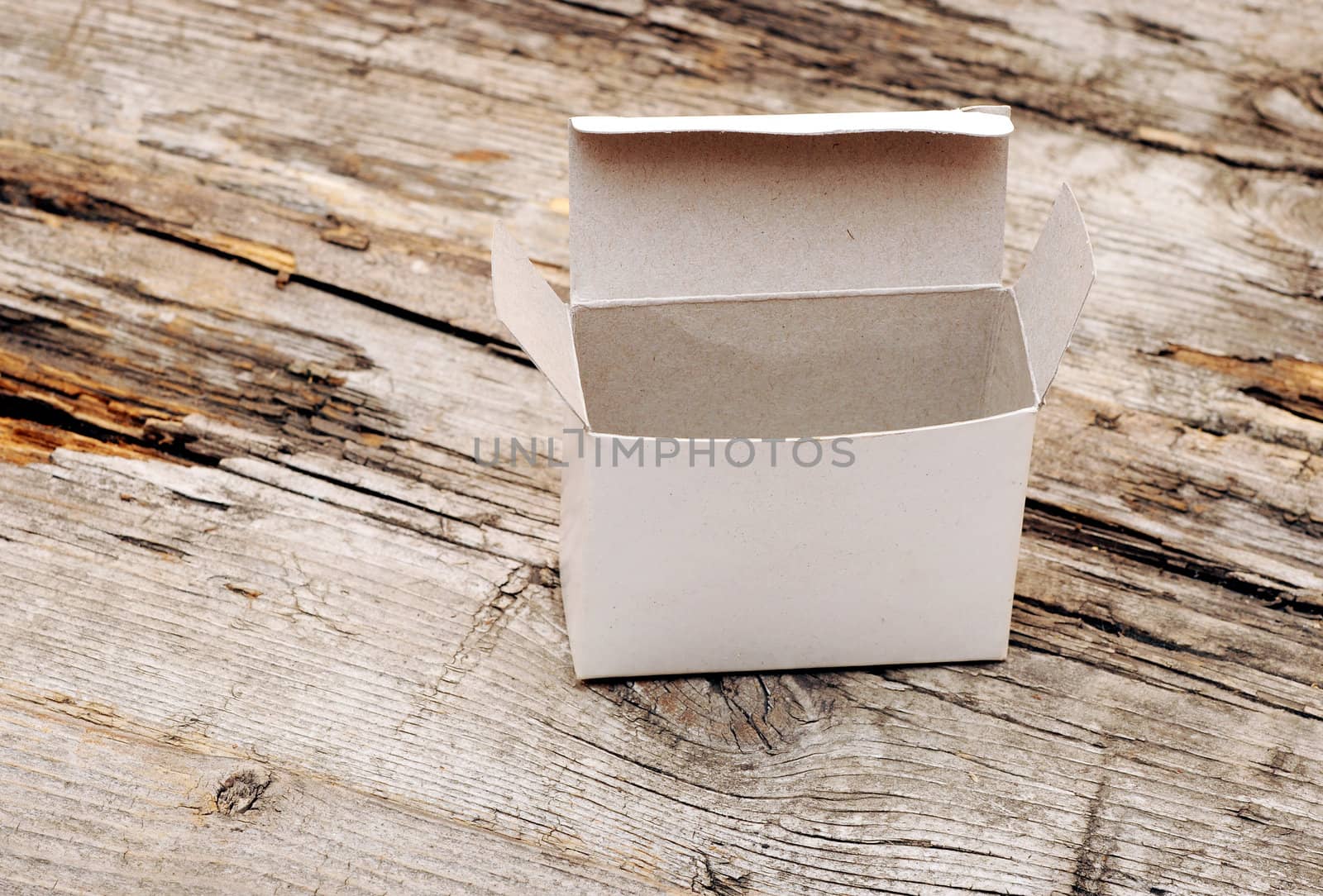 open white box on old wooden table