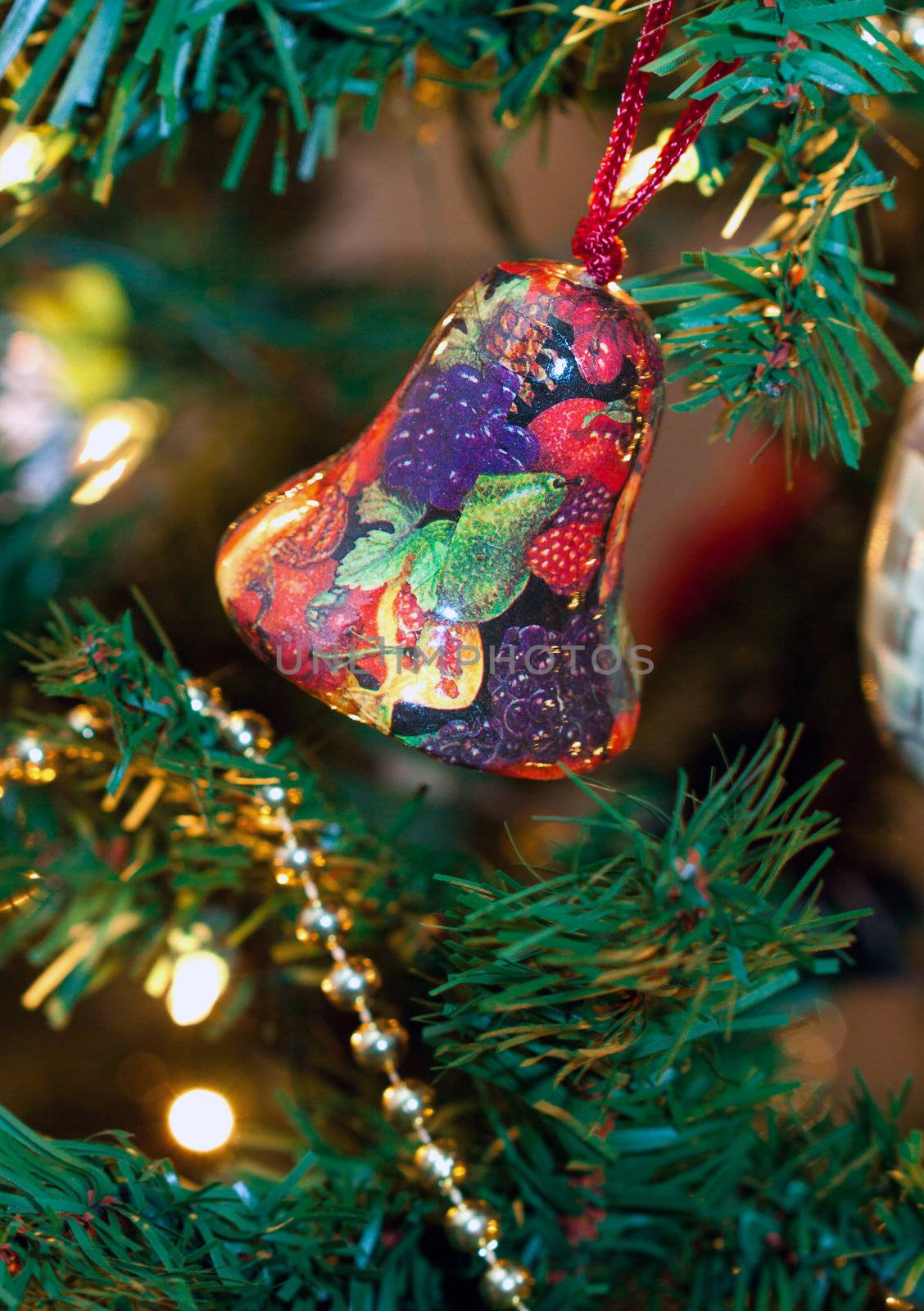 Christmas Bell ornamented with fruits on a Christmas Tree