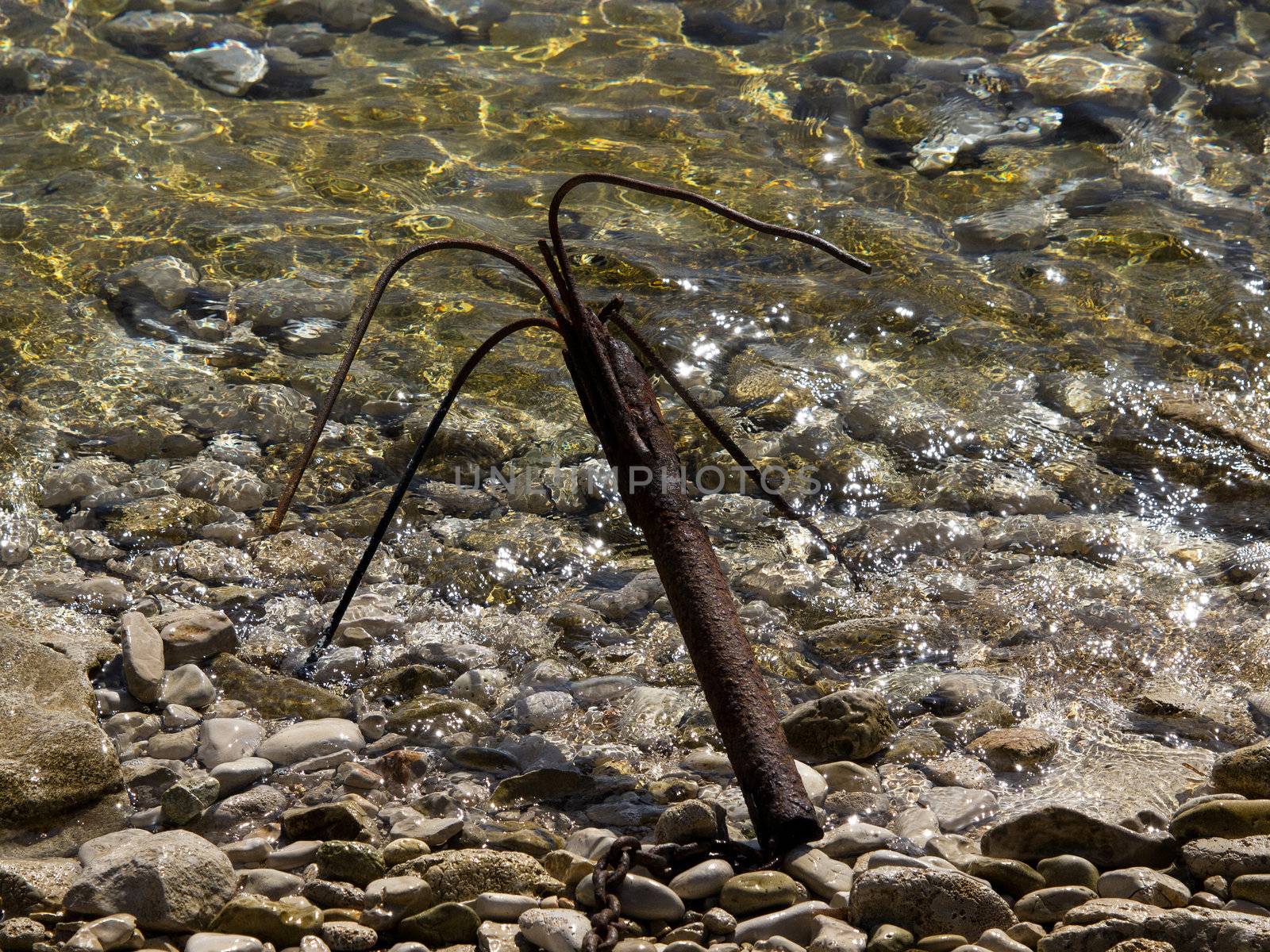 old rusty anchor in the sea