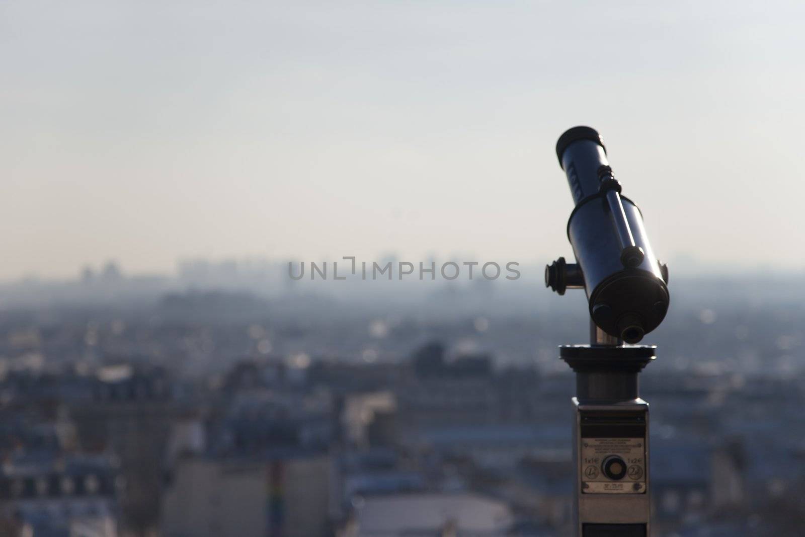 Telescope on top of Montmartre Paris with the city on the background