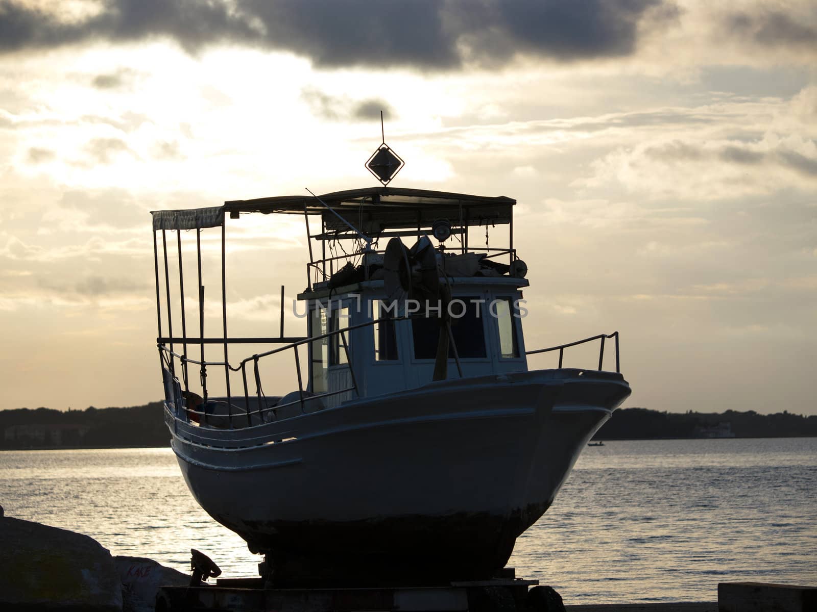 boat on the shore in sunset