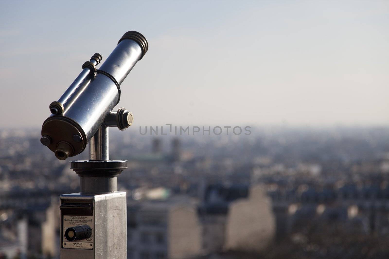 Telescope on top of Montmartre Paris with the city on the background