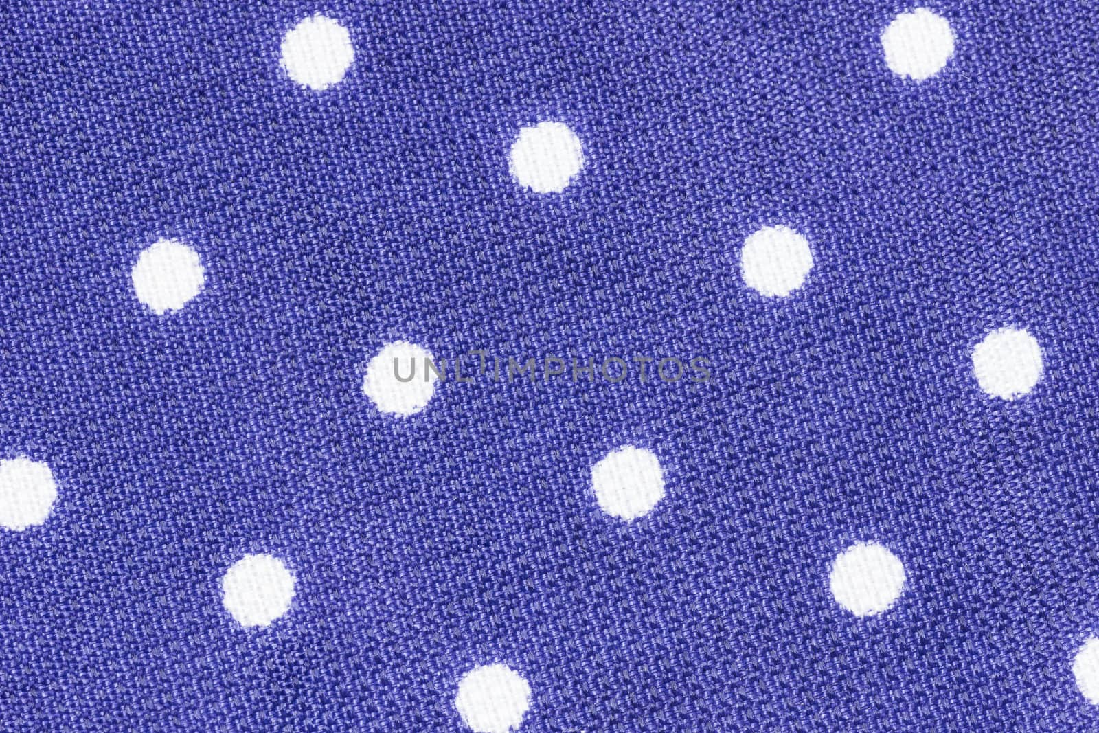 Close up shot of violet polka dot seamless fabric texture