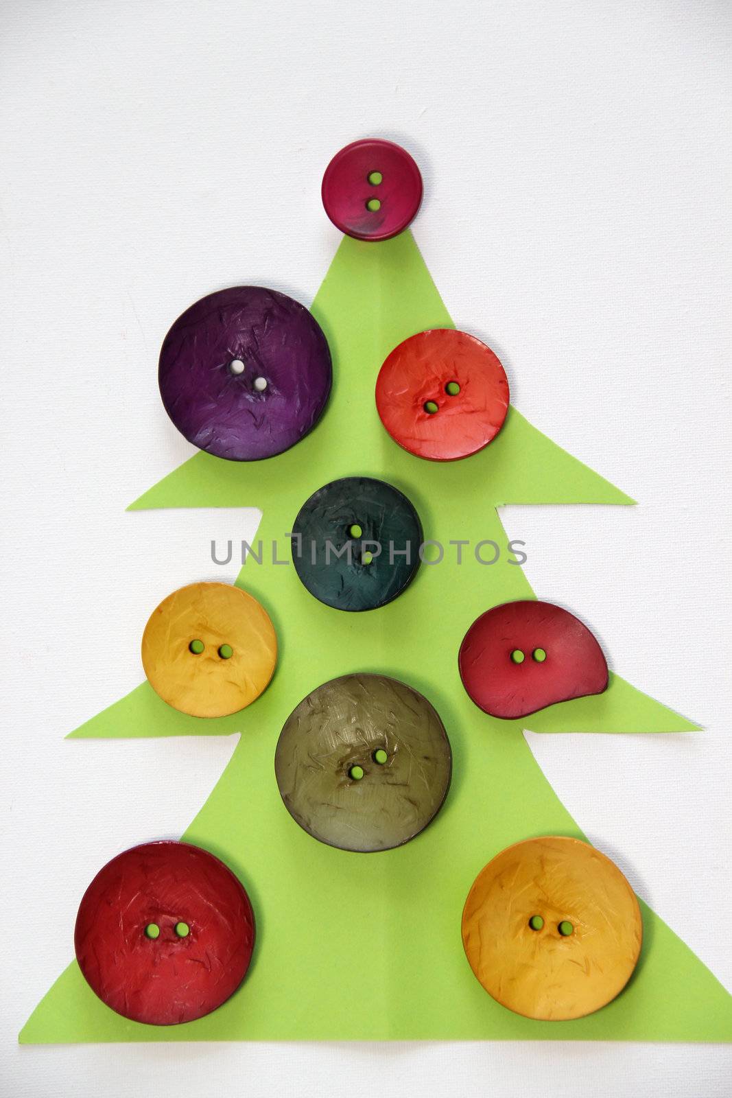 Paper Christmas tree decorated with vivid buttons and funny toys 