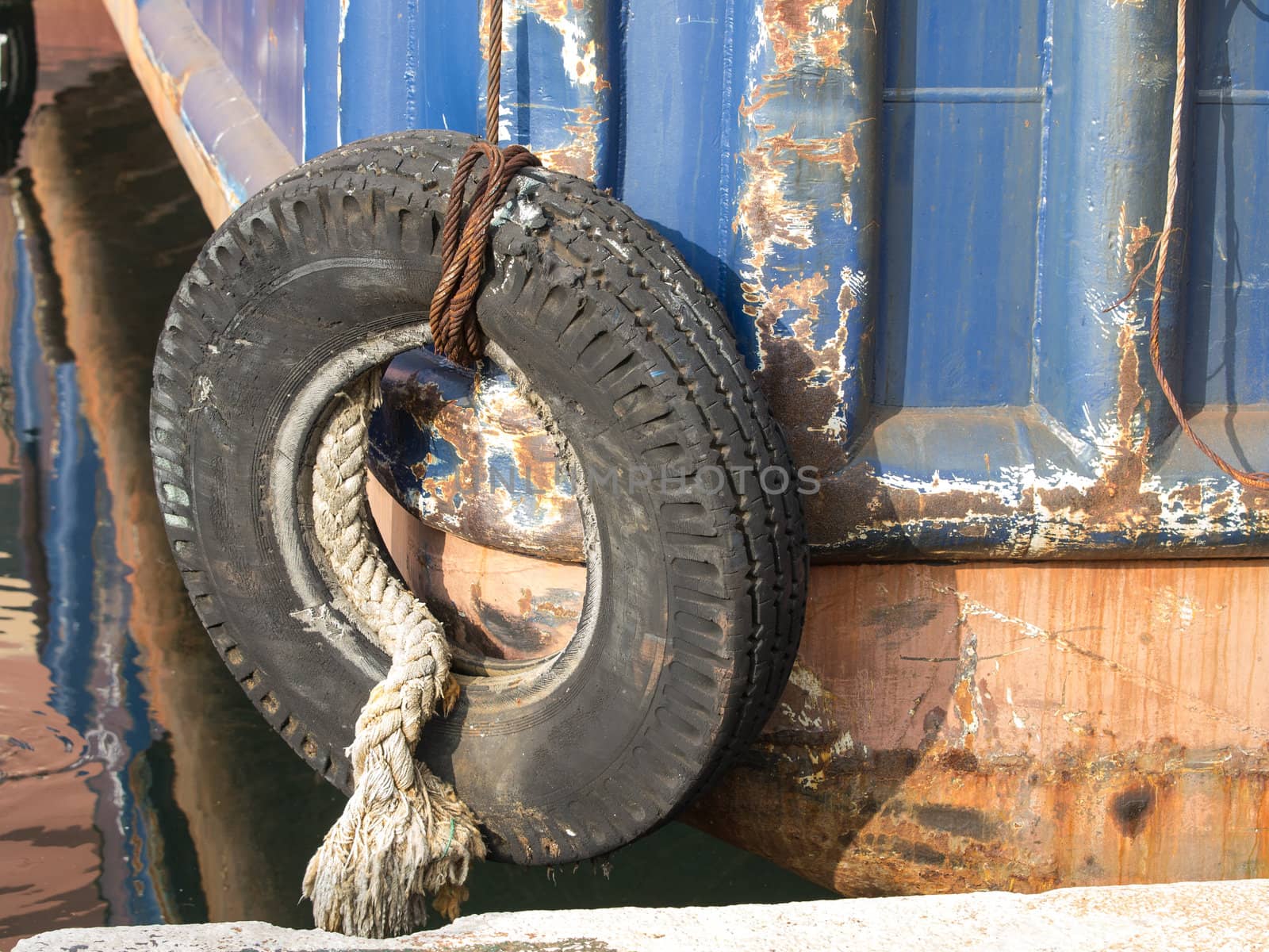 old tyre as a bumper on the boat