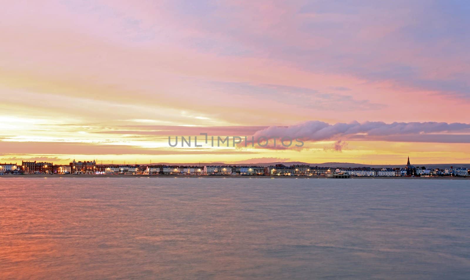 The sunsets over Weymouth seafront taken from view over the sea