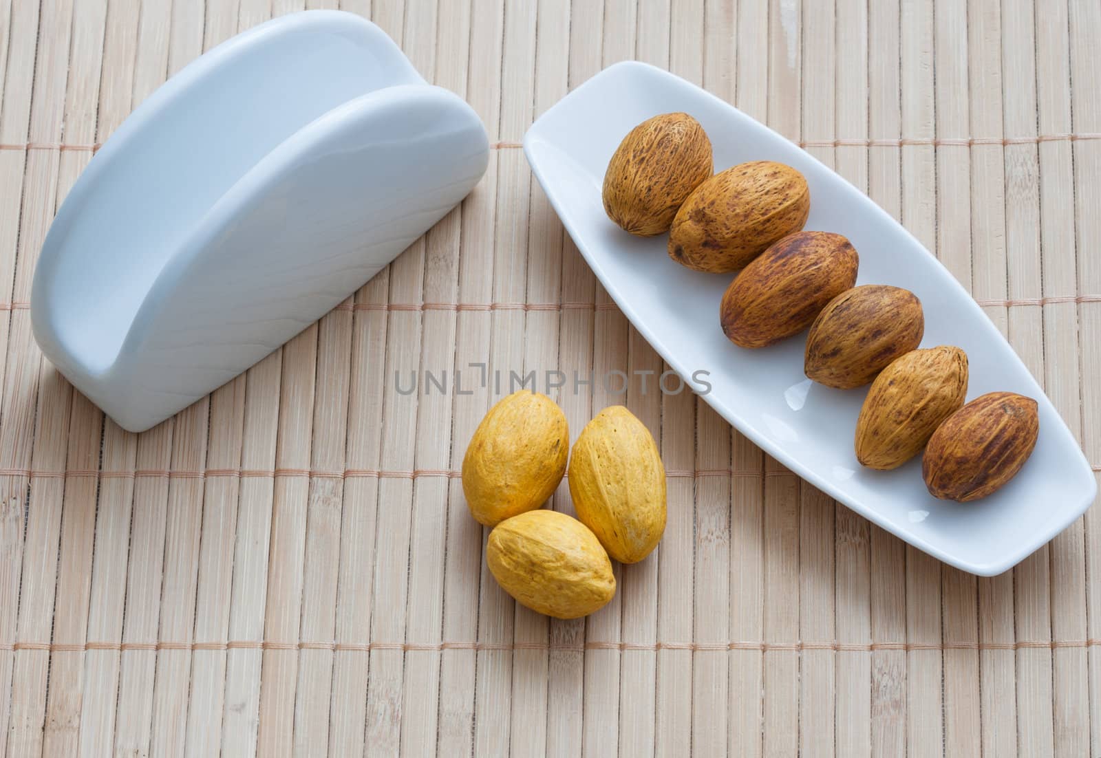 nuts on a plate next to the napkin by sfinks