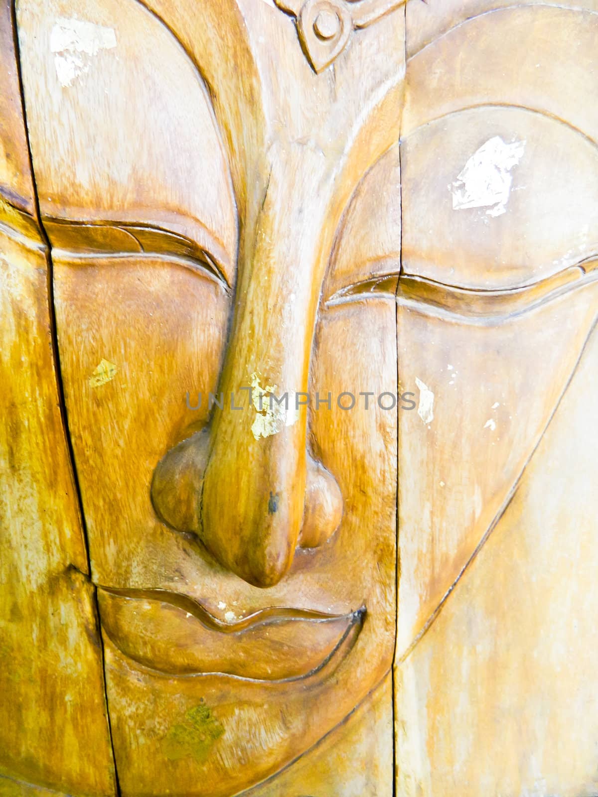 face of a buddha wood handmade.Sculptures in the temple.  by wasan_gredpree