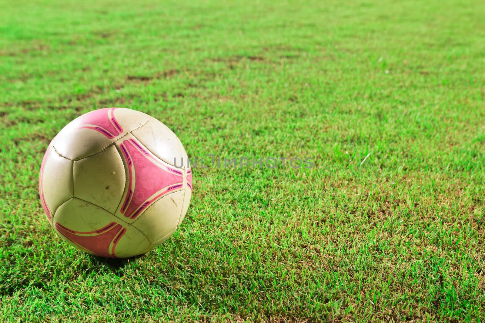 soccer Football on line of Soccer field with player playing socc by wasan_gredpree