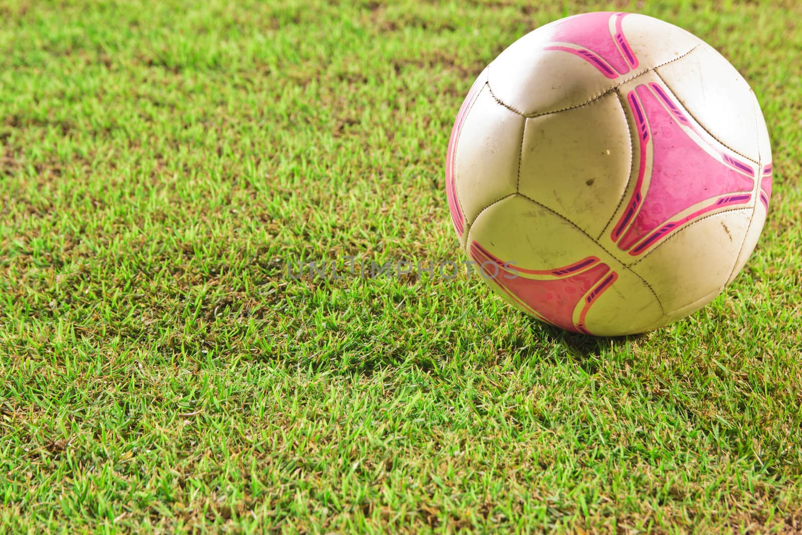 soccer Football on line of Soccer field with player playing socc by wasan_gredpree