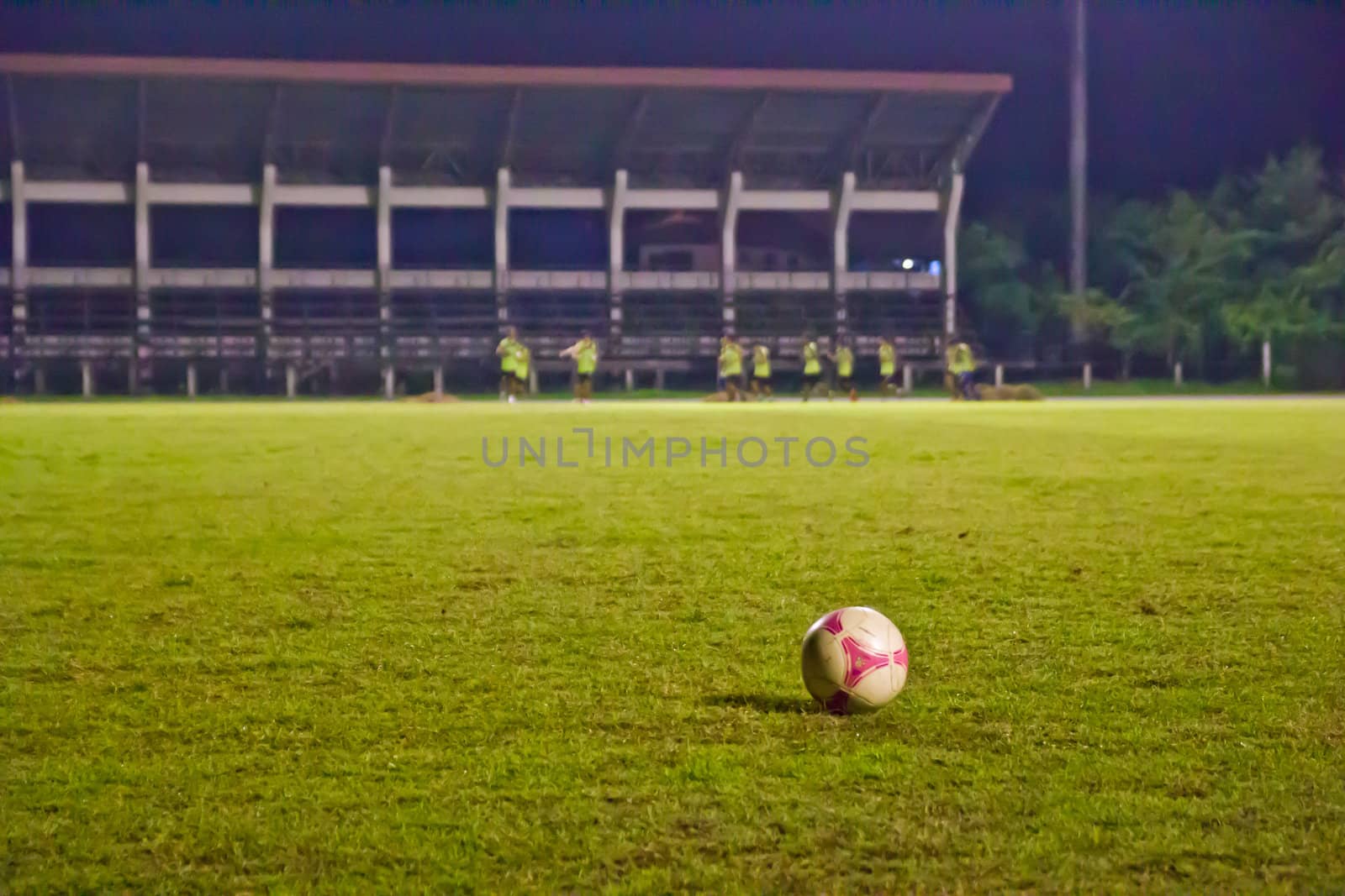 Soccer Football on line of Soccer field with player playing socc by wasan_gredpree