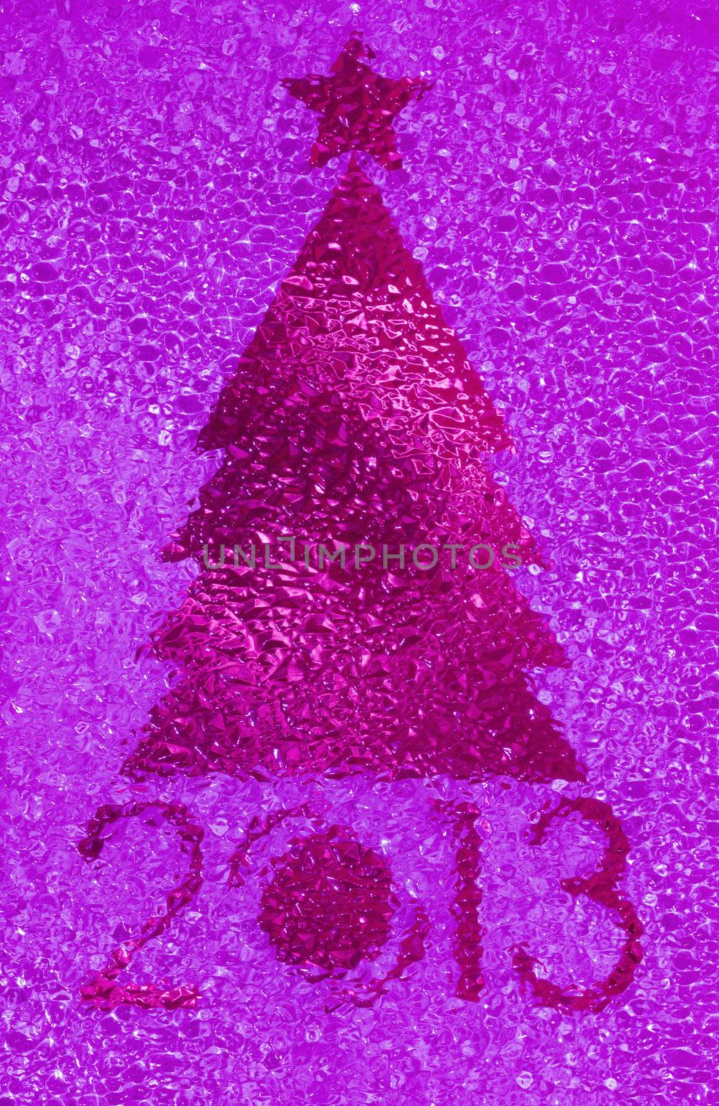 Closeup shot of Christmas tree crystal magenta background