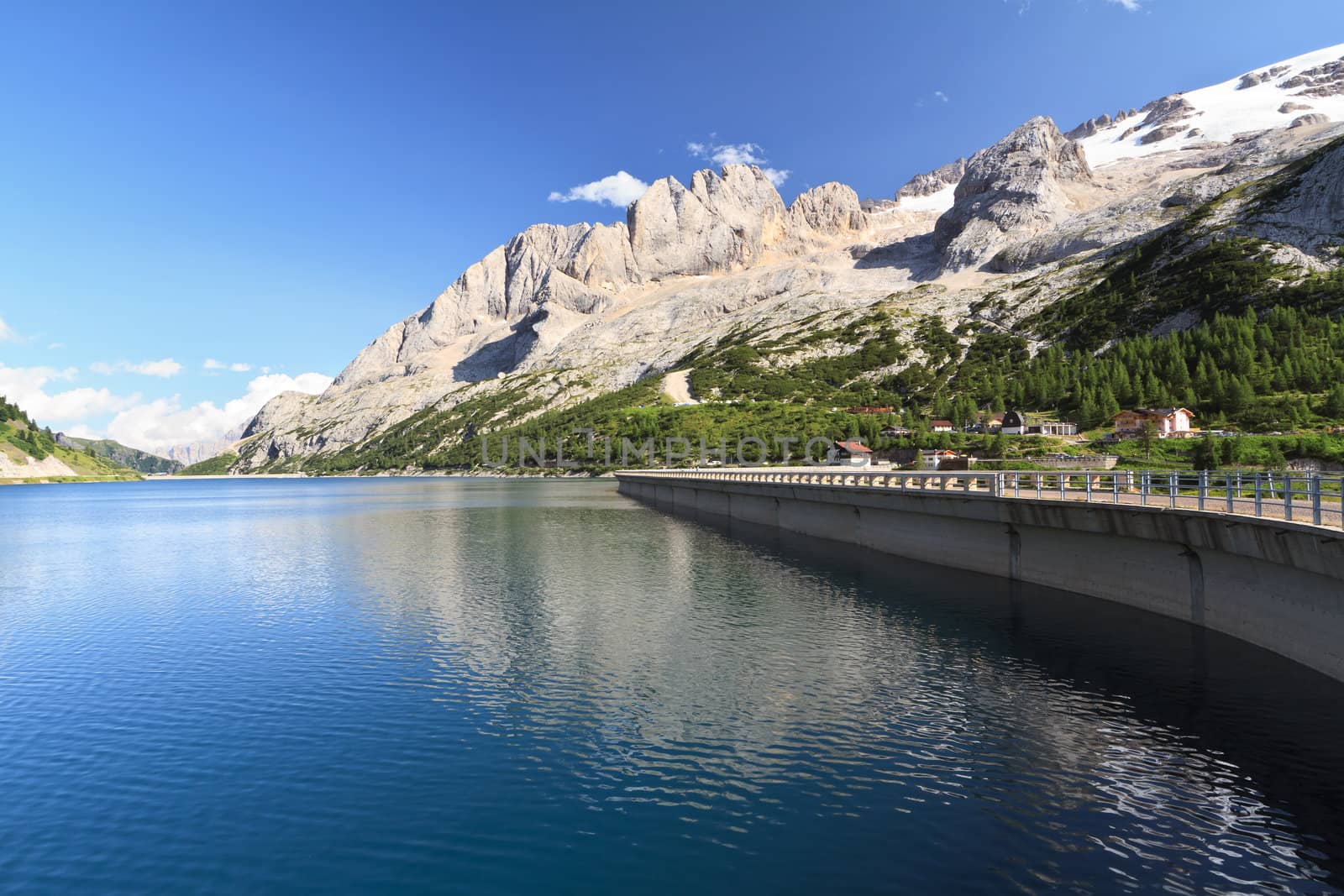 summer view of Fedaia lake beneath Marmolada glacier, Trentino, Italy