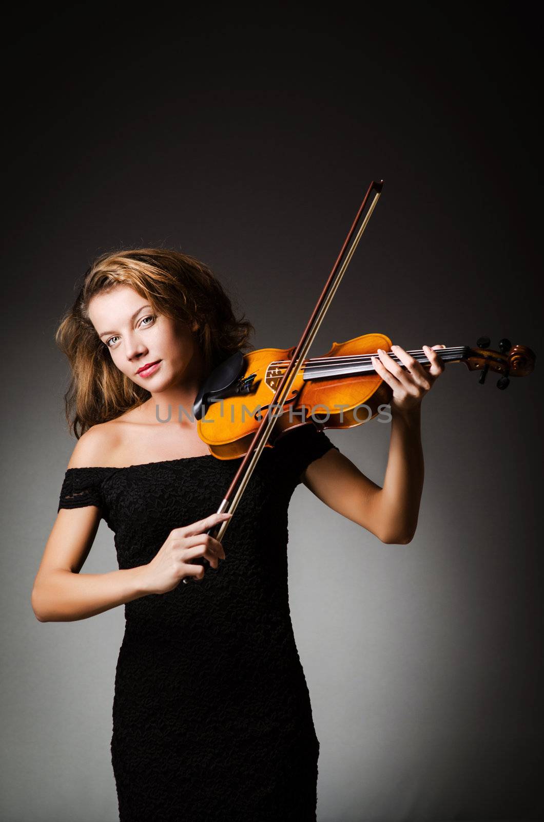Woman performer with violin in studio by Elnur