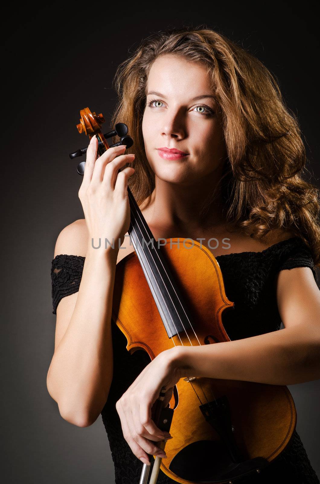 Woman performer with violin in studio