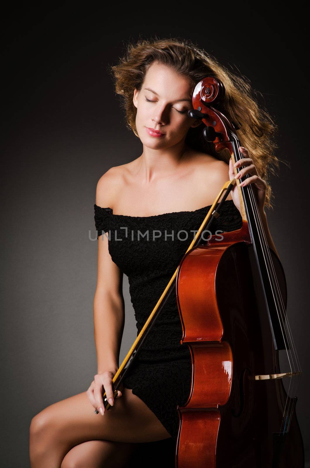 Woman performer with cello  in studio by Elnur
