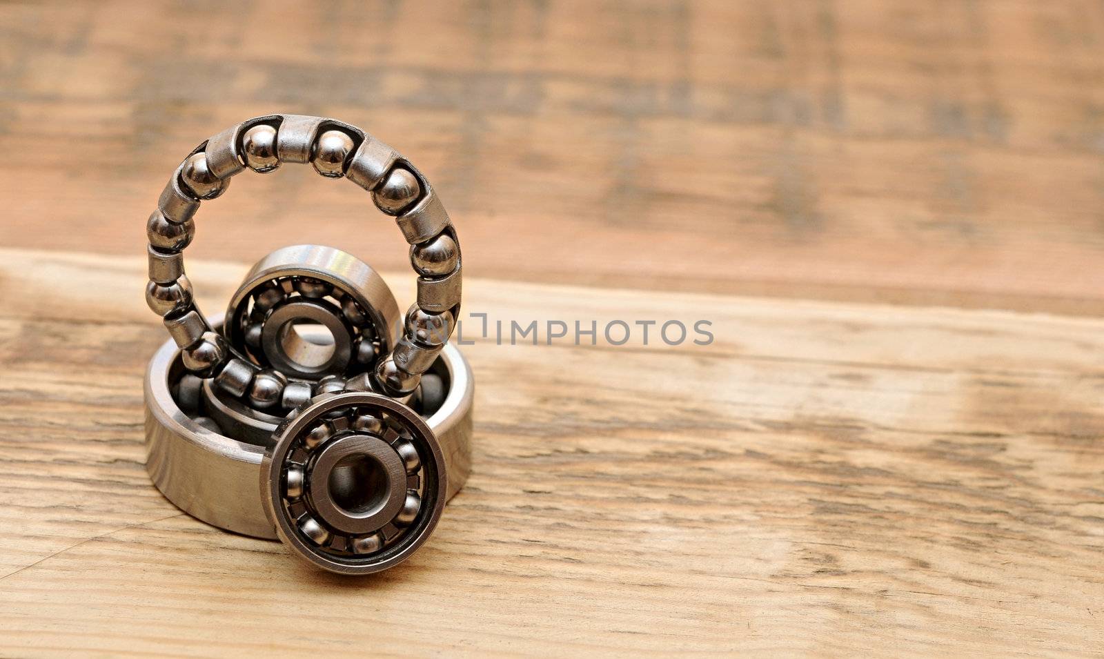 steel ball bearings on wooden table. space for your text by inxti