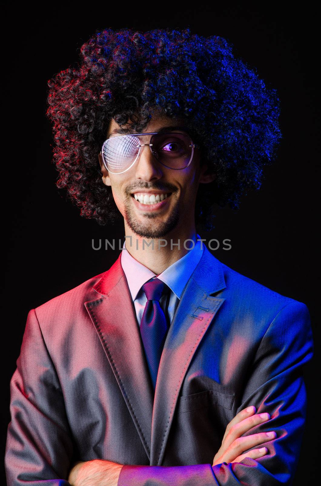 Singer with afro cut in dark studio