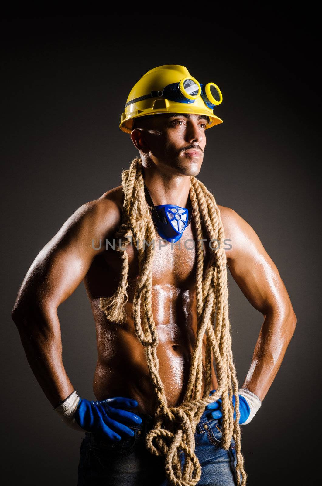 Construction worker in dark studio