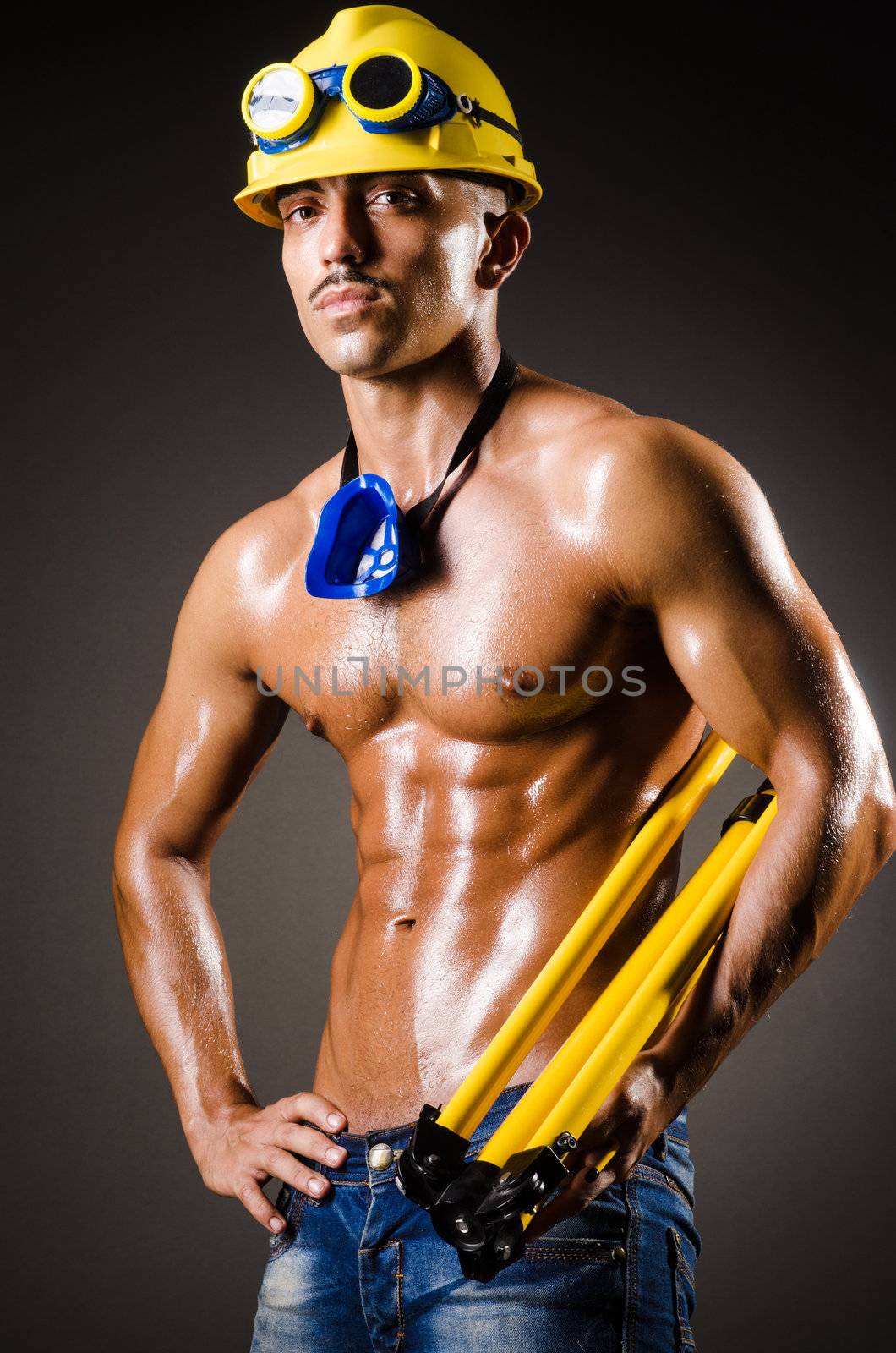 Construction worker in dark studio