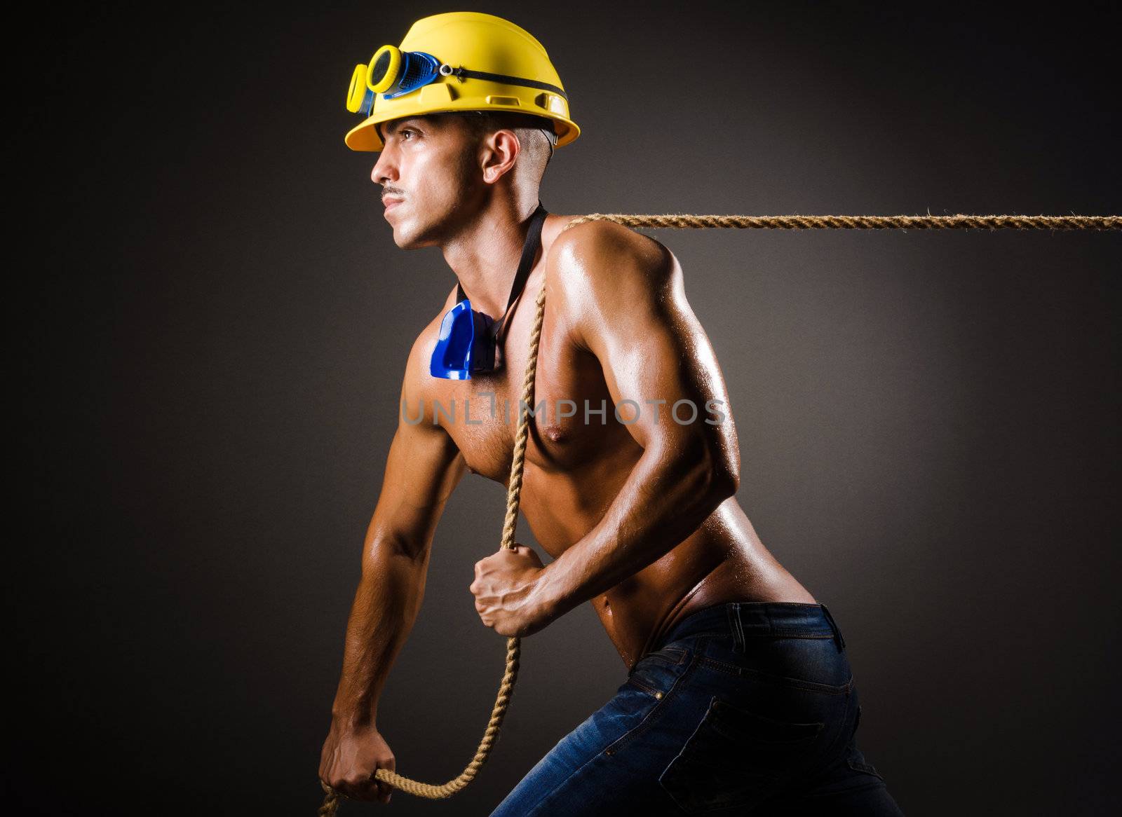 Nude builder pulling rope in darkness by Elnur