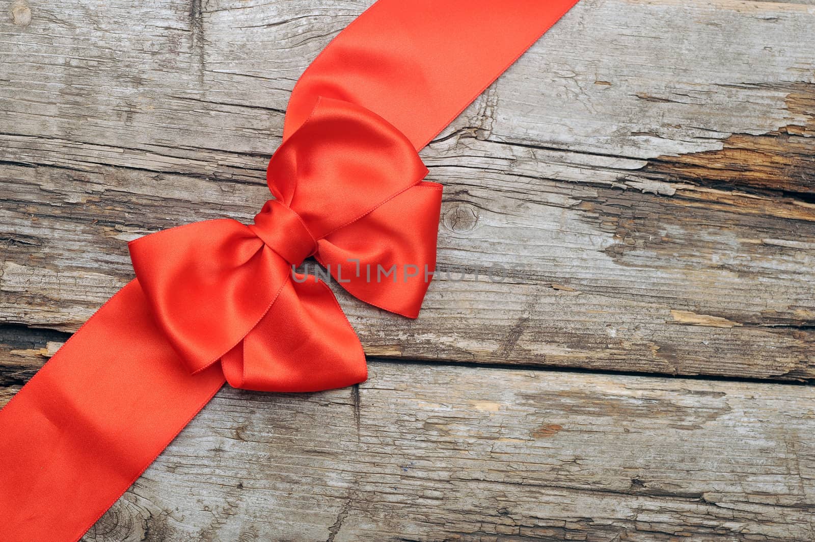 Red bow with copy space on old wood