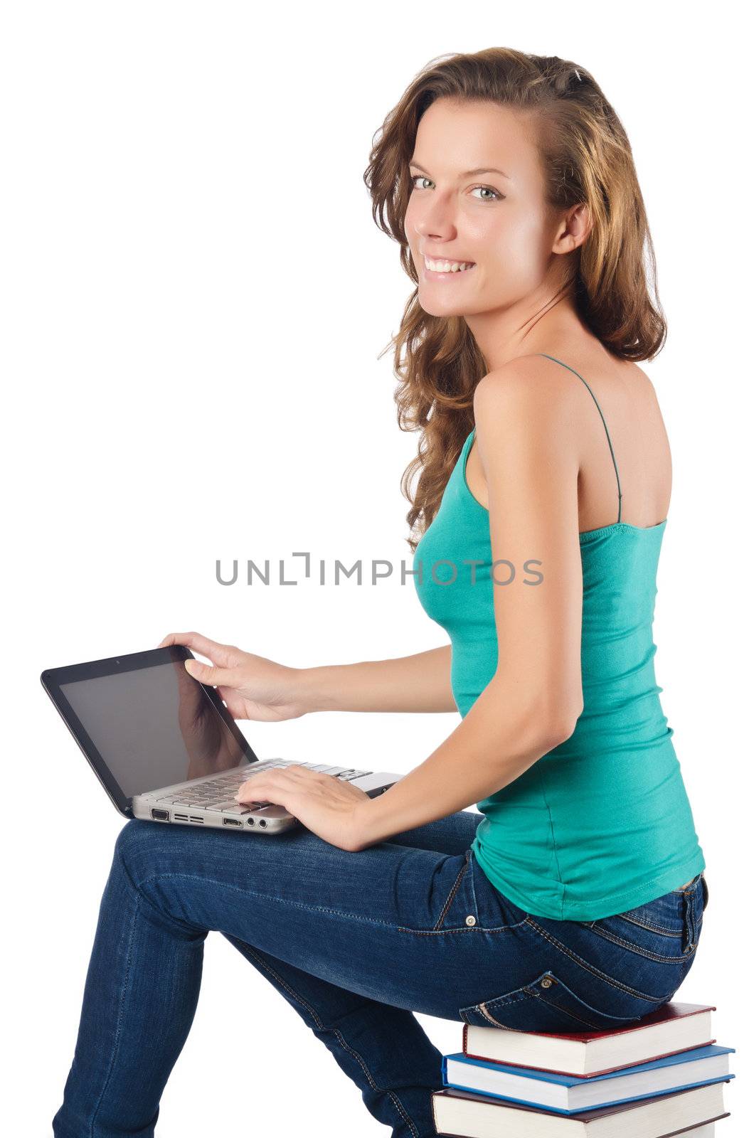 Student with netbook sitting on books by Elnur