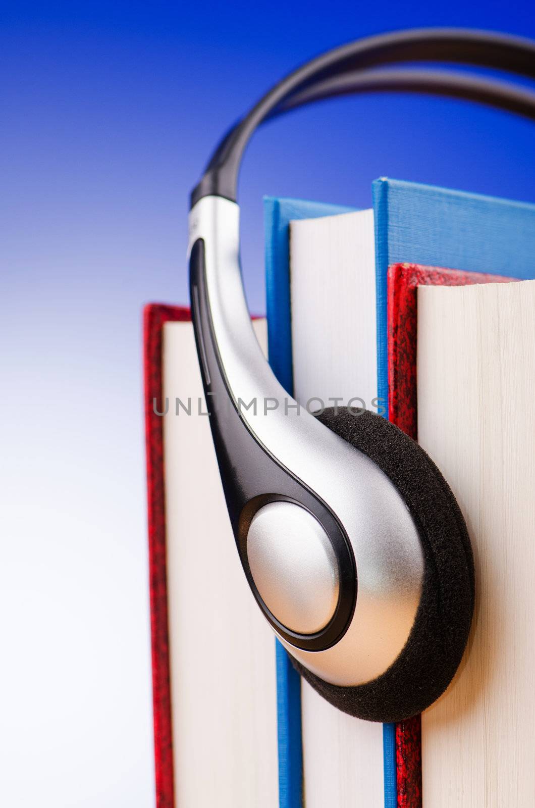 Concept of audio books with earphones on white