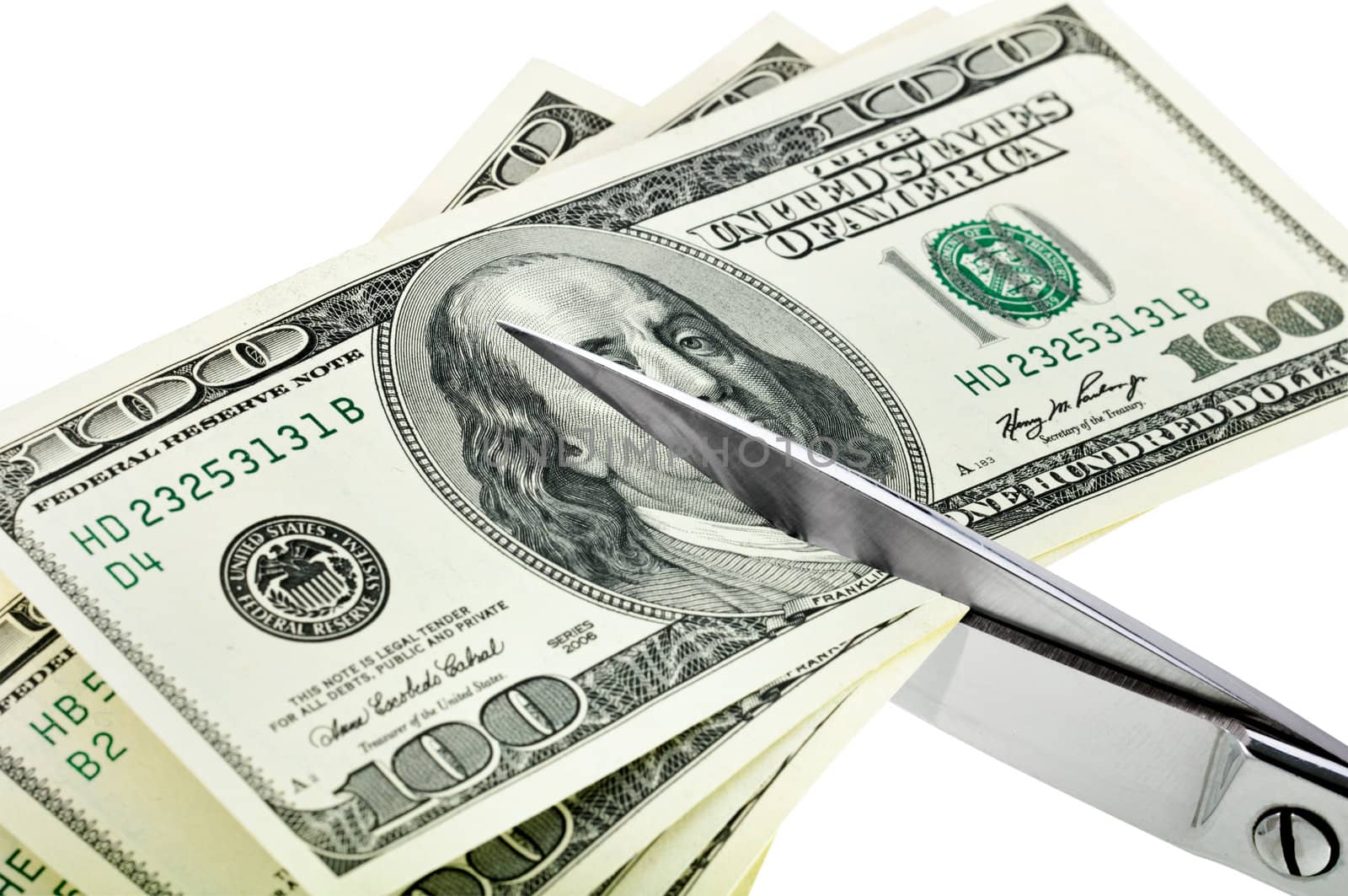 Business concept. Dollars are cutting with scissors. by lobzik