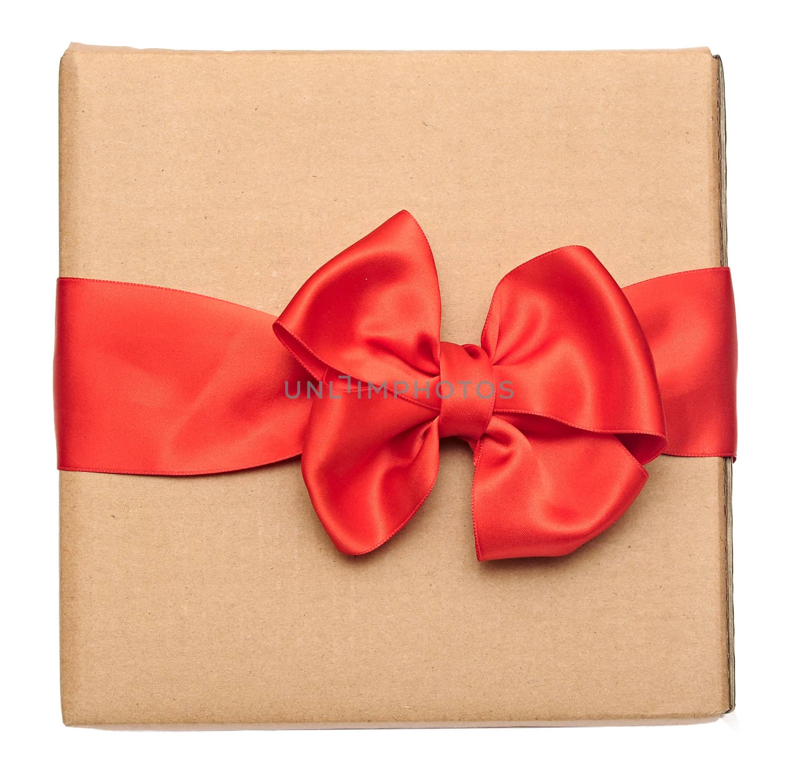 red ribbon bow over recycled nature paper cardboard. holidays background 