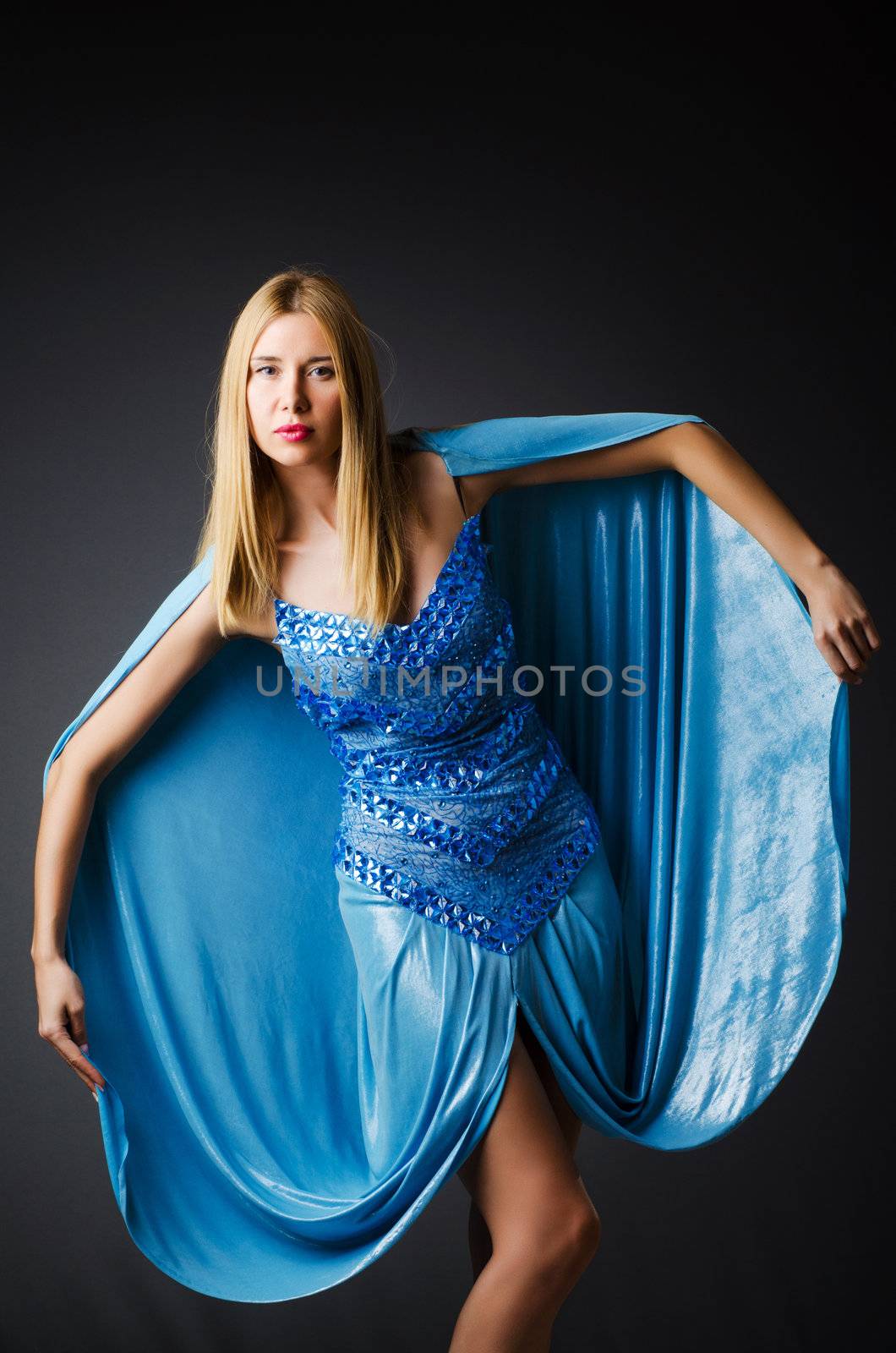 Attractive woman in blue dress on white by Elnur