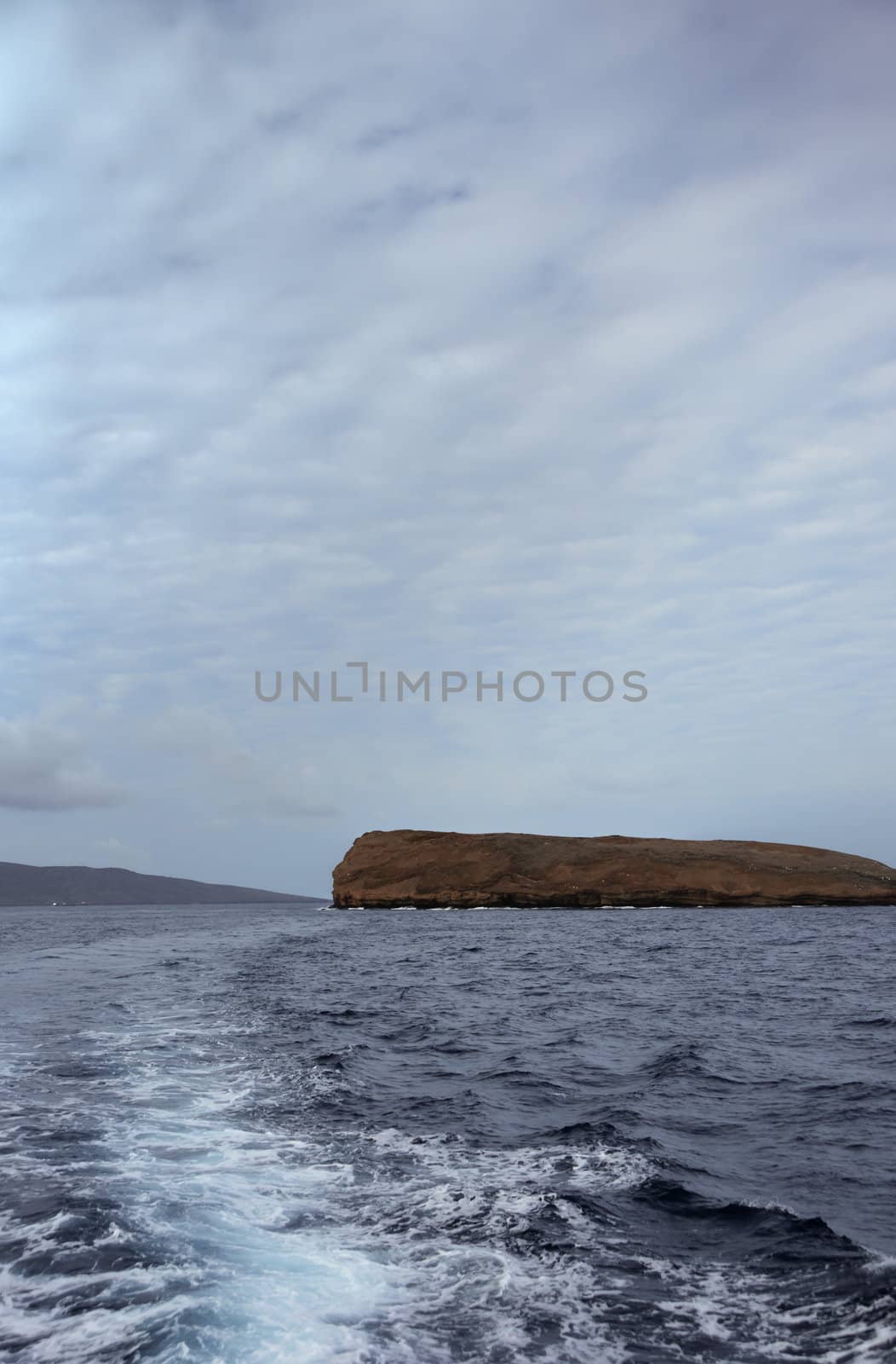 Boat wake leaving Molokini Island off the coast of Maui, Hawaii