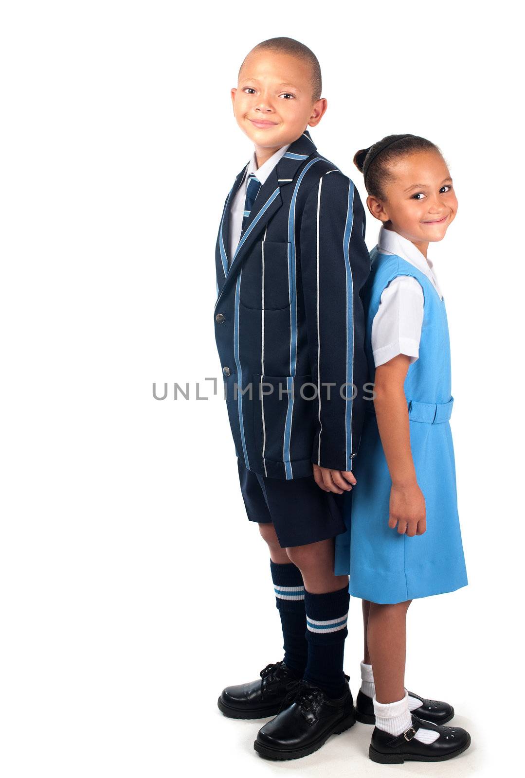A happy brother and sister in school uniform appear ready to go to school