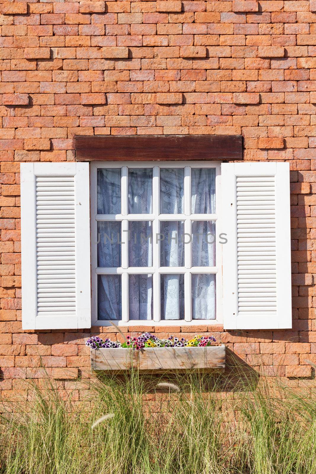 Vintage white window on red brick wall