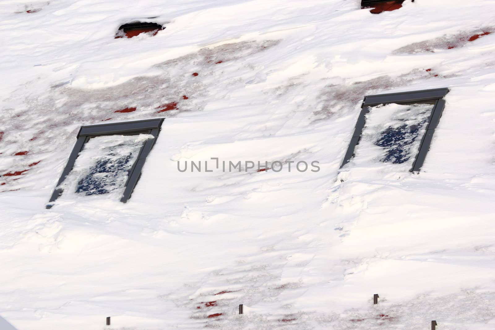 big snow covering the roof windows from a mansard